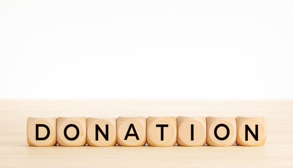 Donation word on wooden block shape